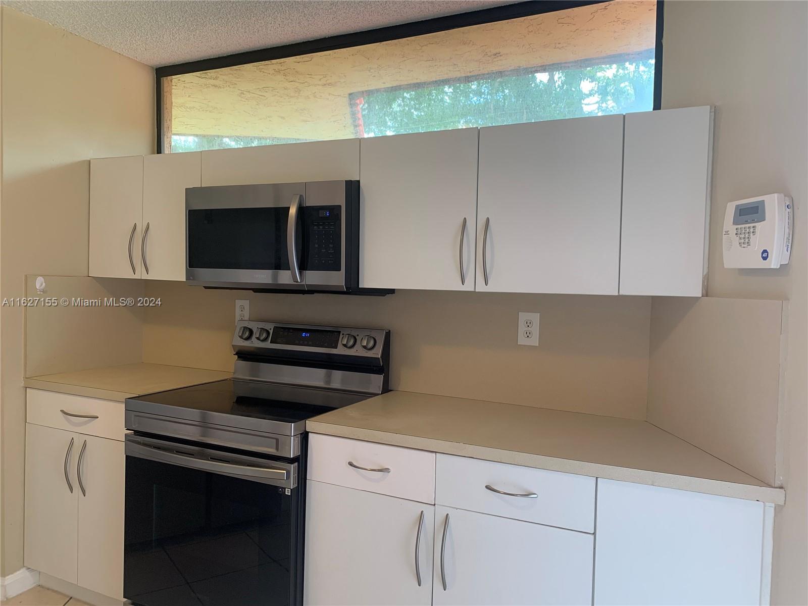 a kitchen with a stove and a microwave