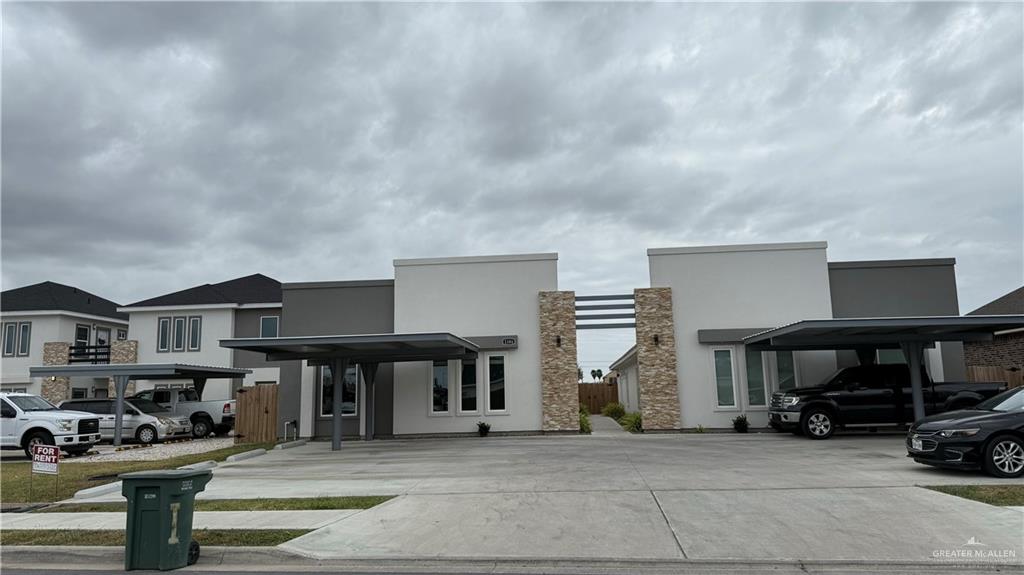 a view of a car park in front of house