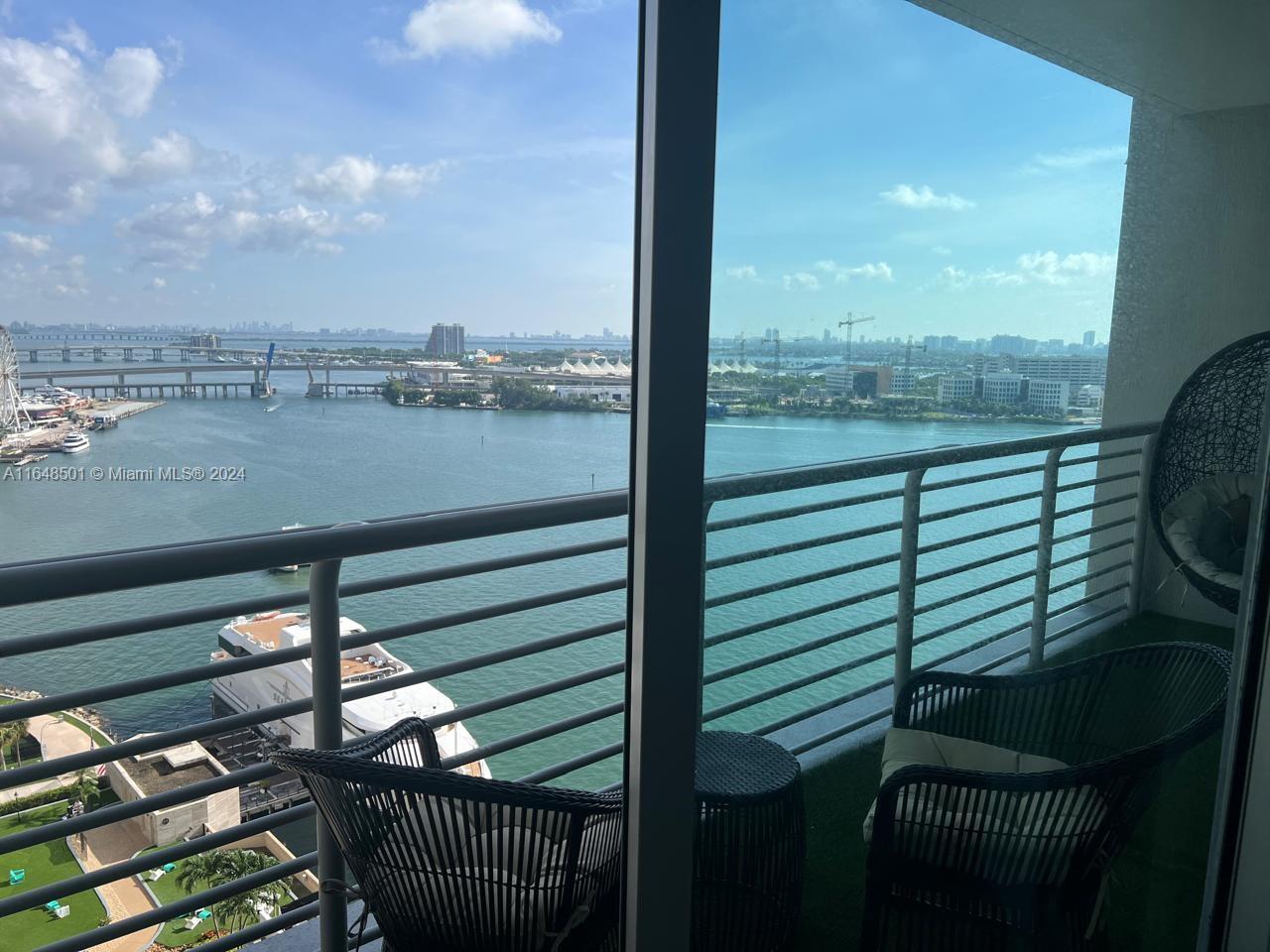 a view of a balcony with floor to ceiling windows with wooden floor