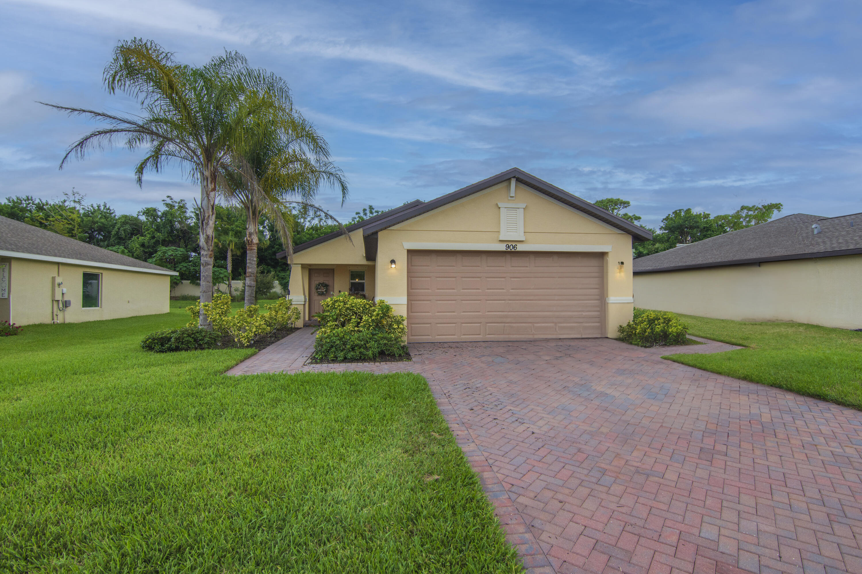 a front view of house with yard and green space