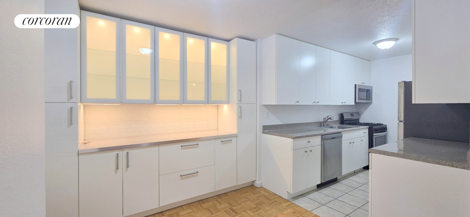 a kitchen with a stove a sink and a refrigerator