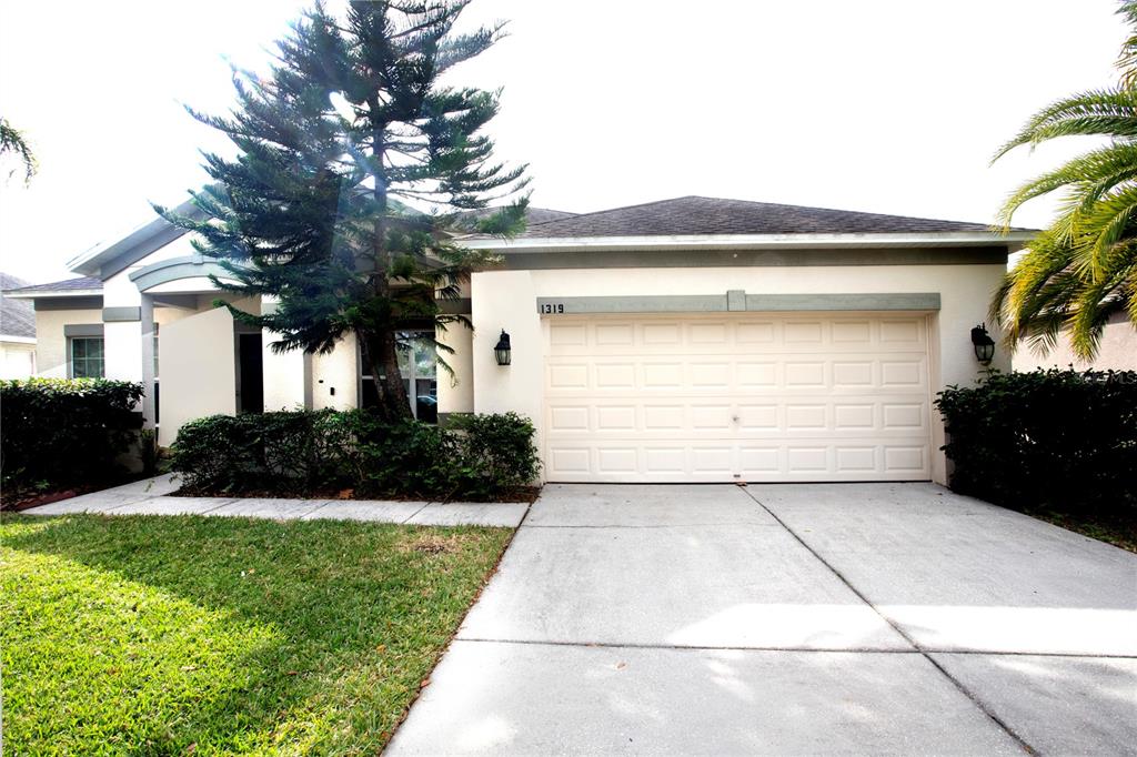 a front view of a house with a yard and garage