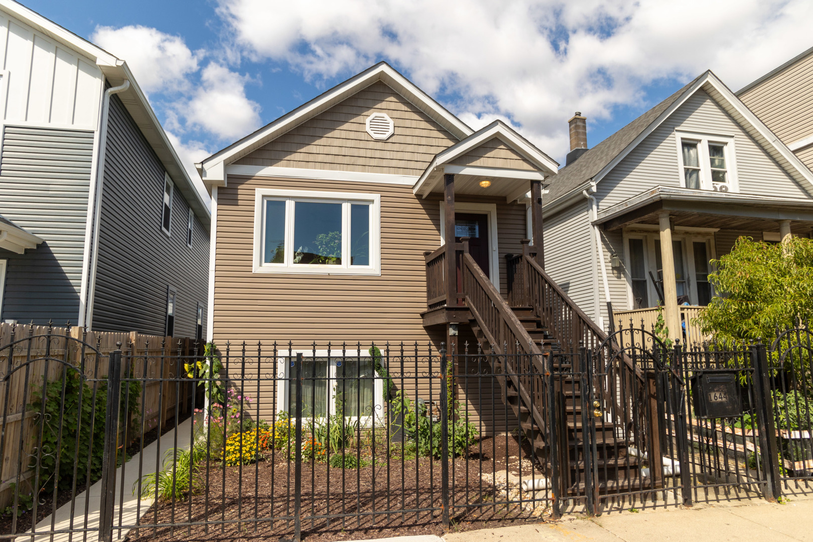 a view of a house with wooden fence