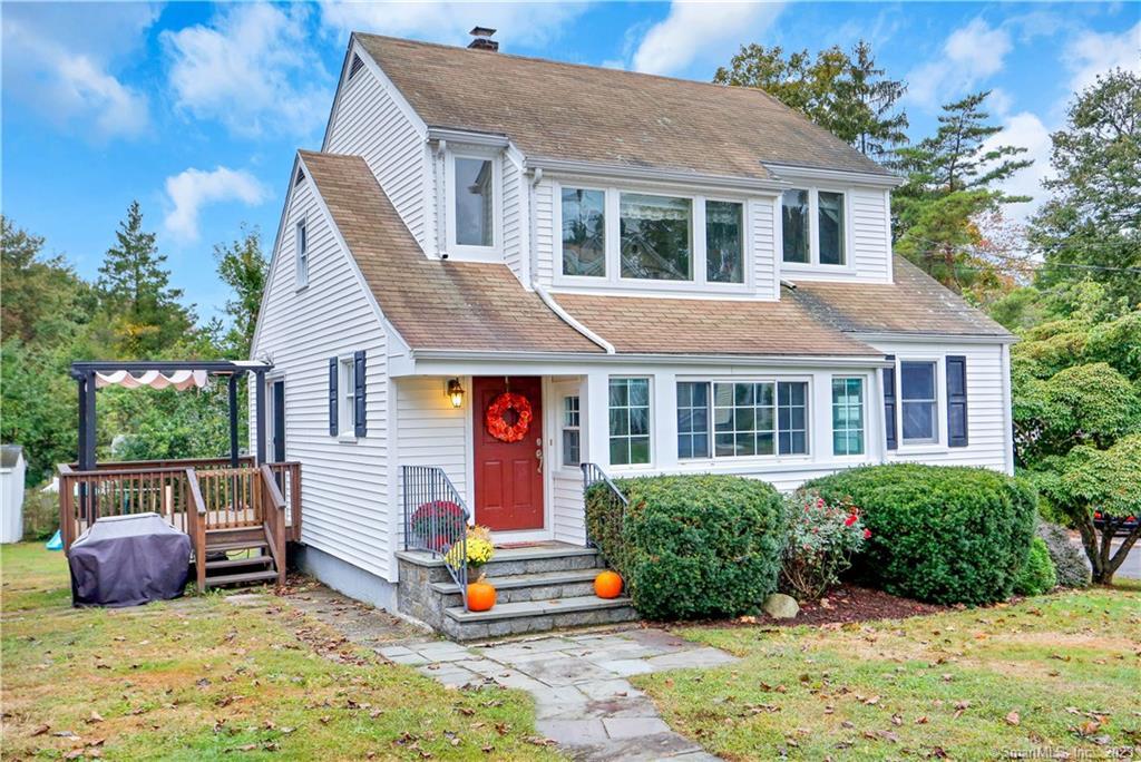 a view of a house with a yard and potted plants