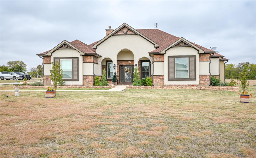 a front view of a house with a yard