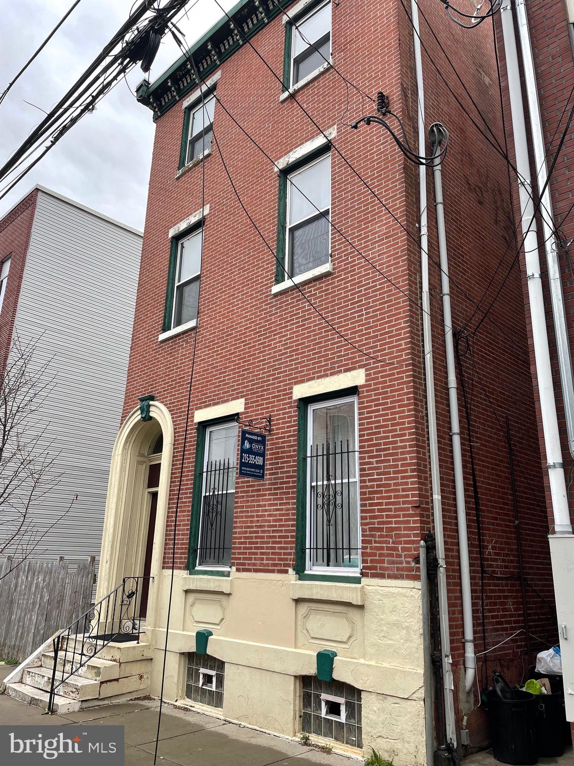 front view of a brick house with a blue door