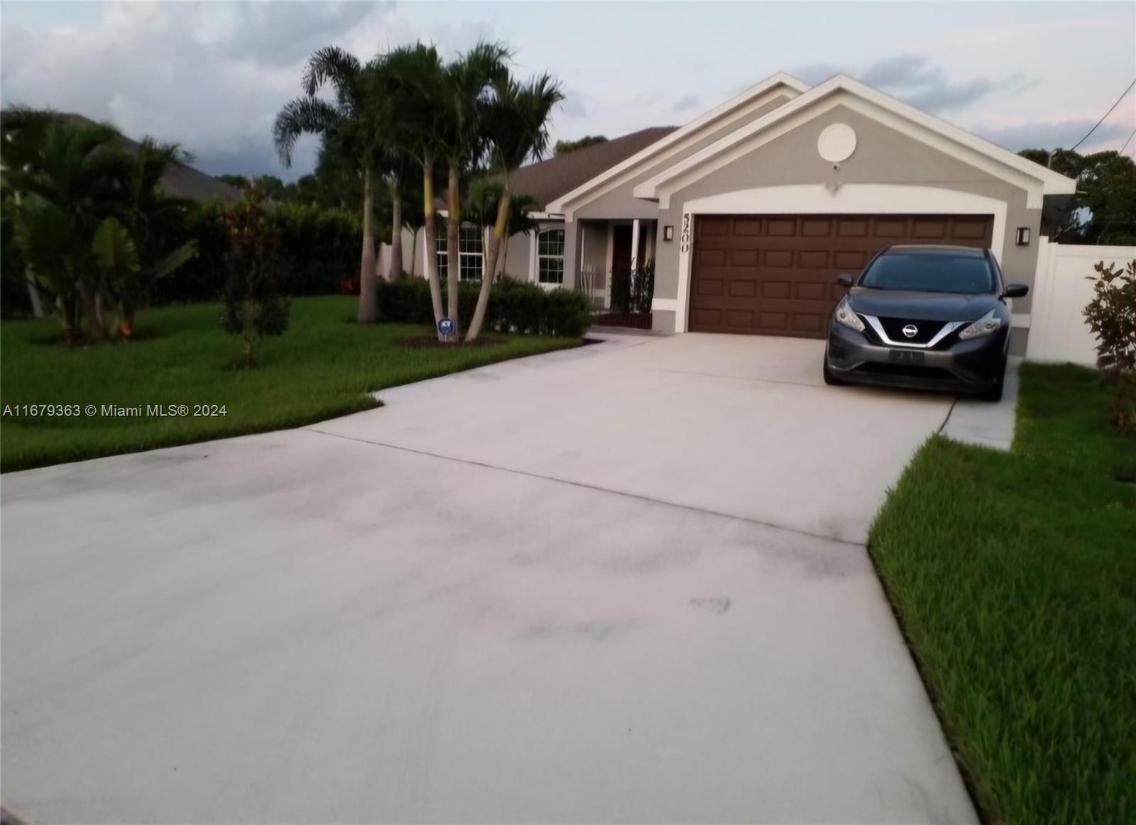 a car parked in front of house with a yard