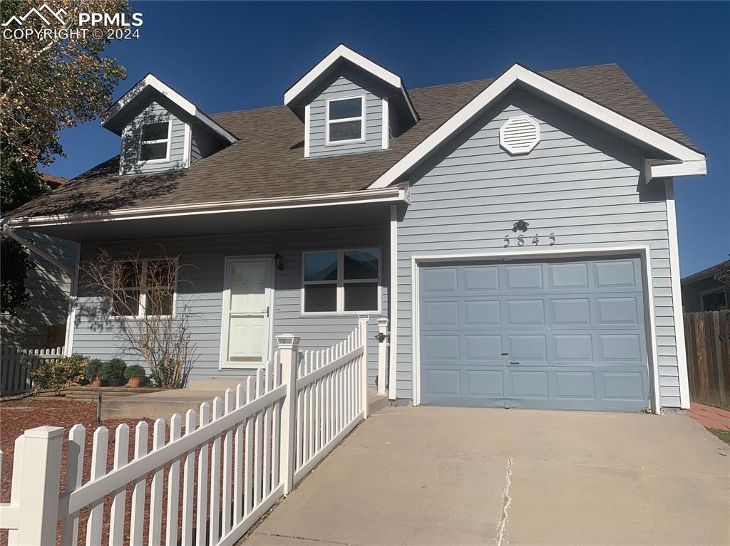 a view of a house with a garage and balcony