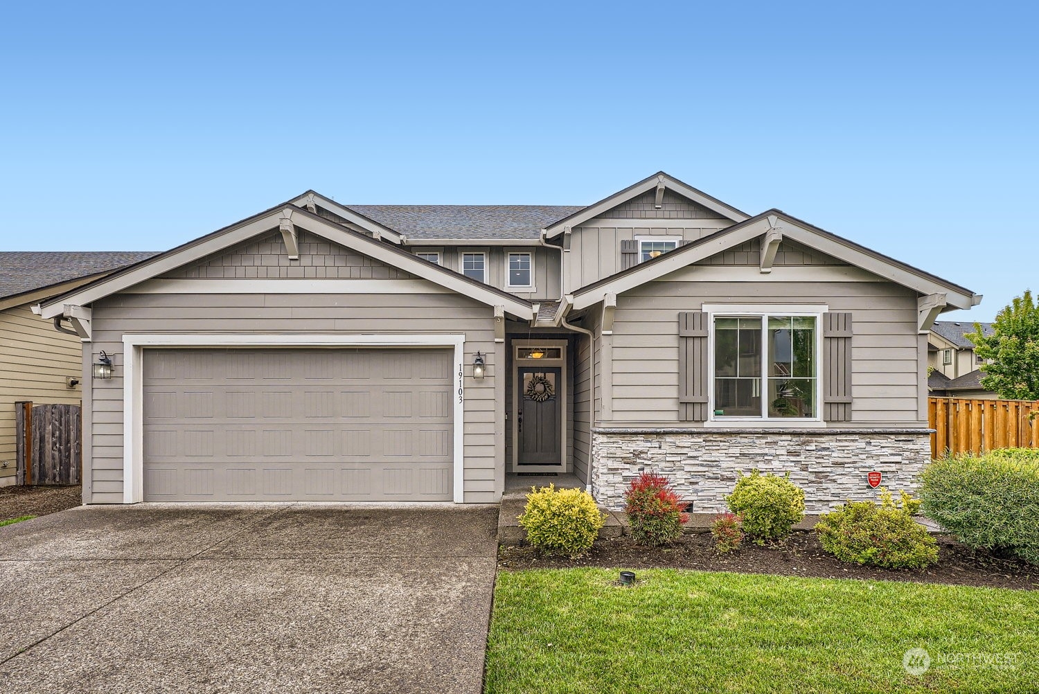 a front view of a house with a yard and garage