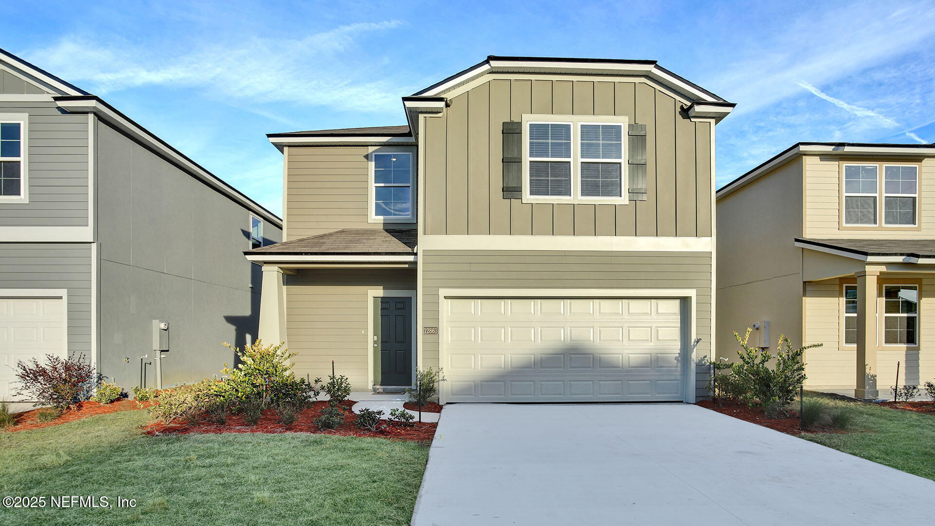 a front view of a house with a yard and garage