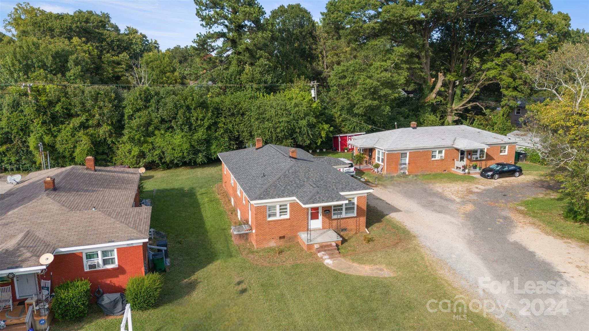 an aerial view of a house with swimming pool and garden