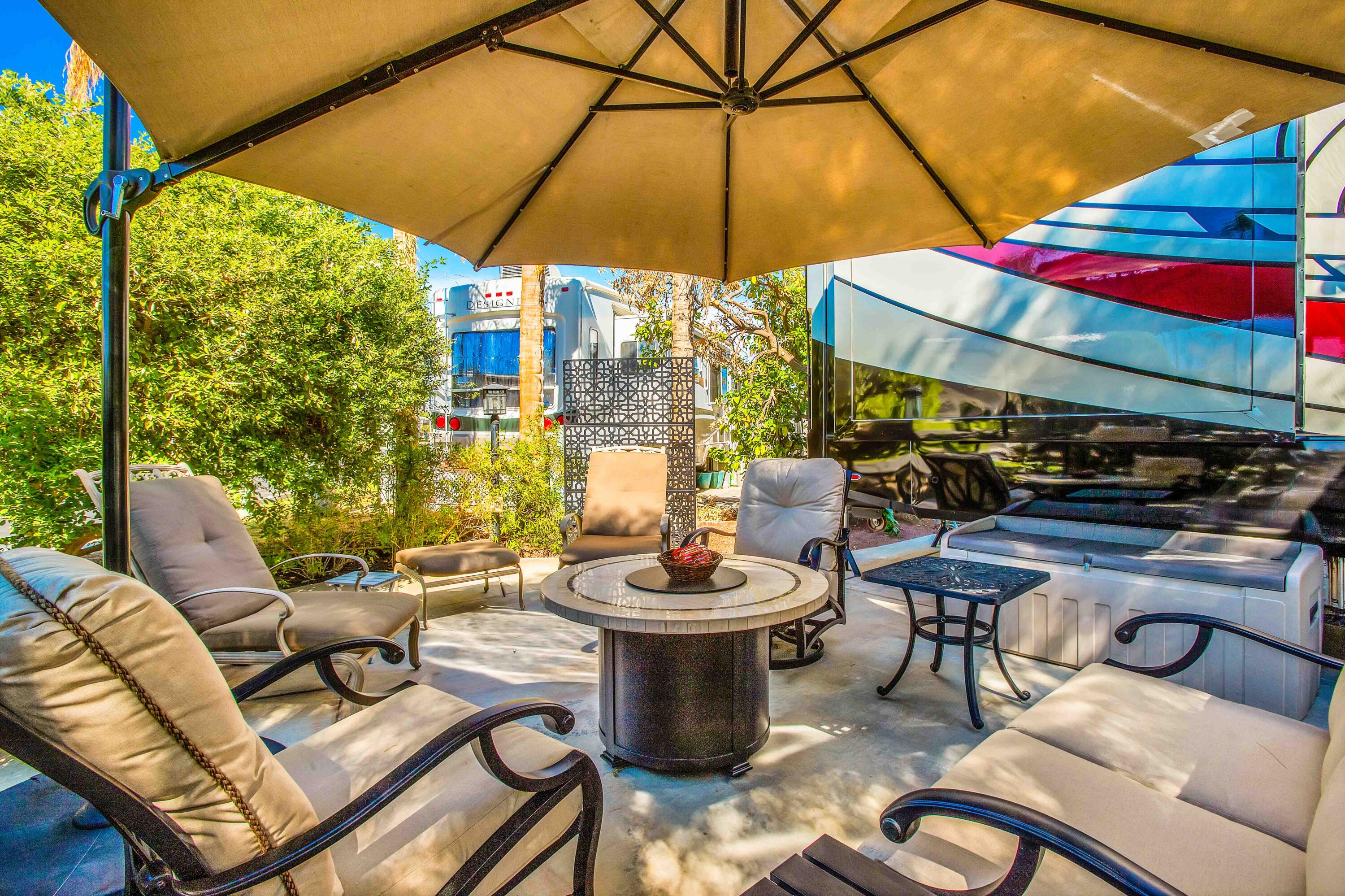 a outdoor living space with furniture and umbrella