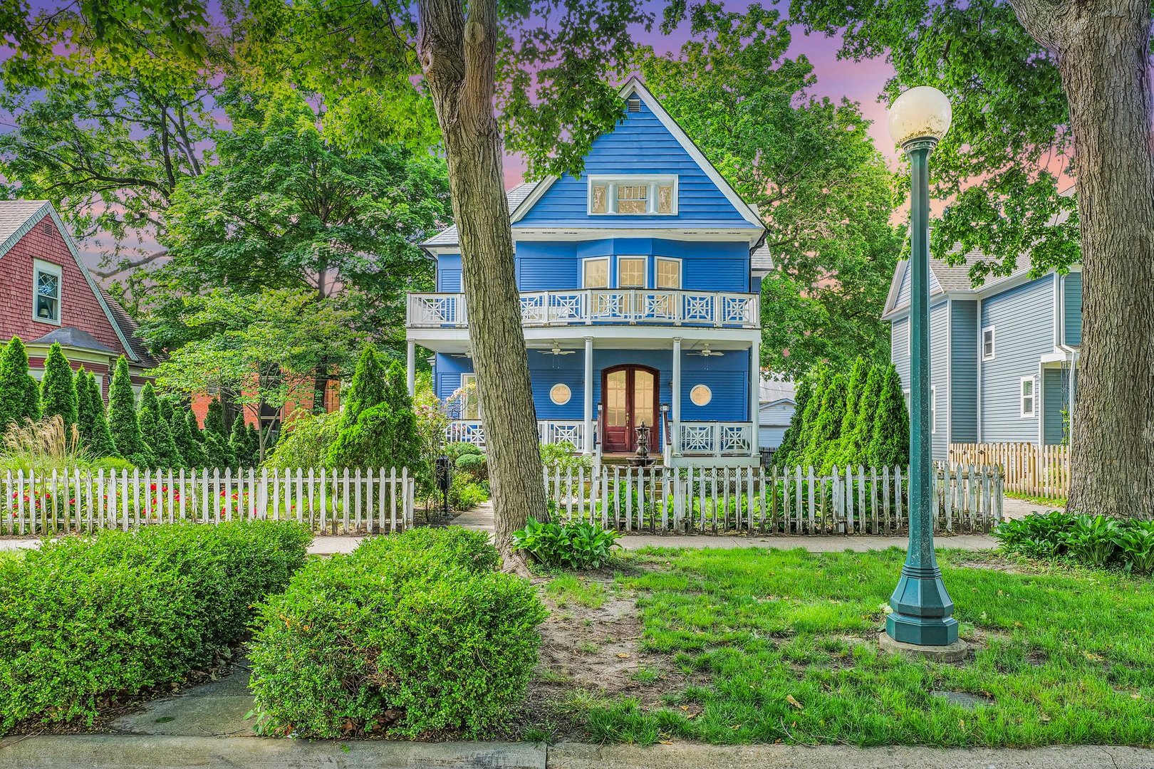 a front view of a house with a garden and plants