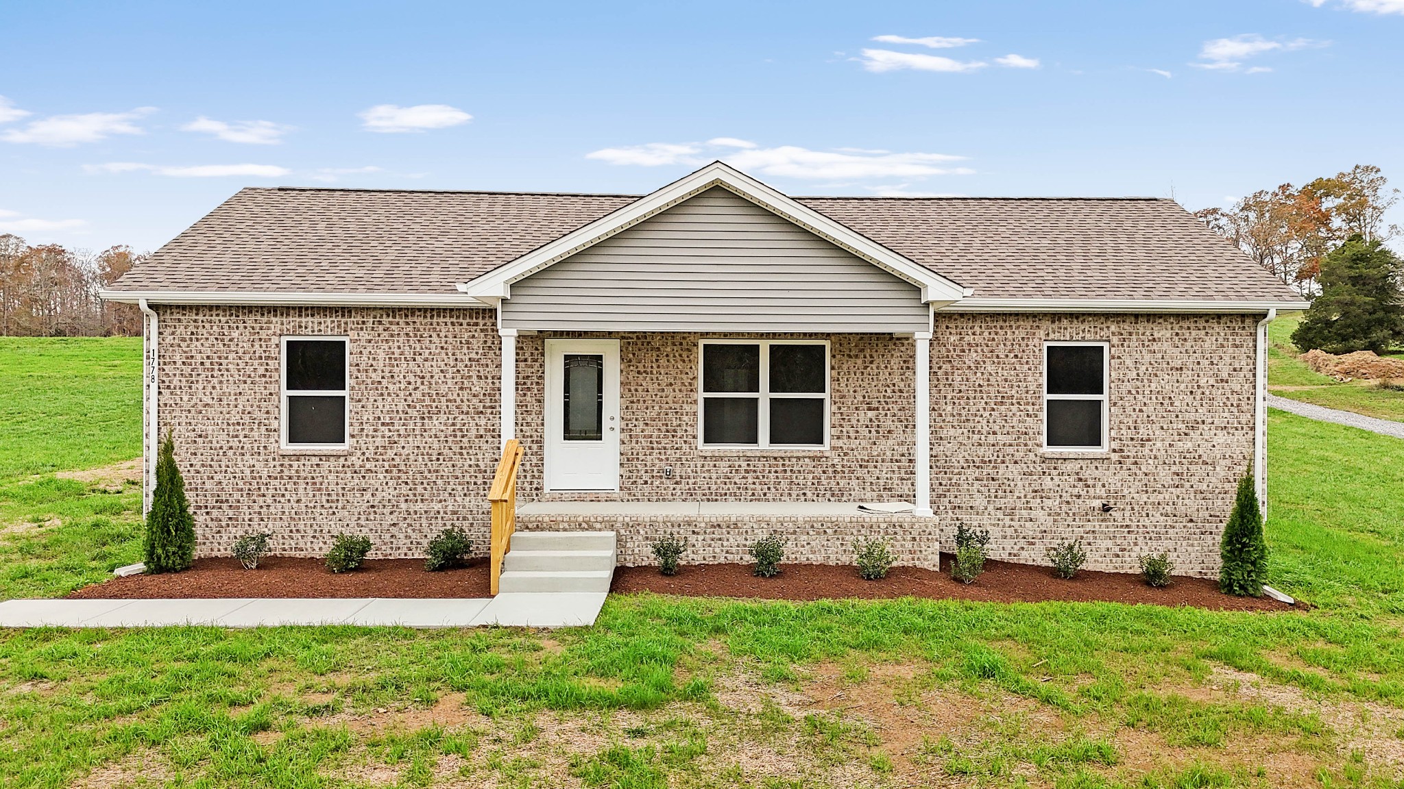 a front view of a house with a garden