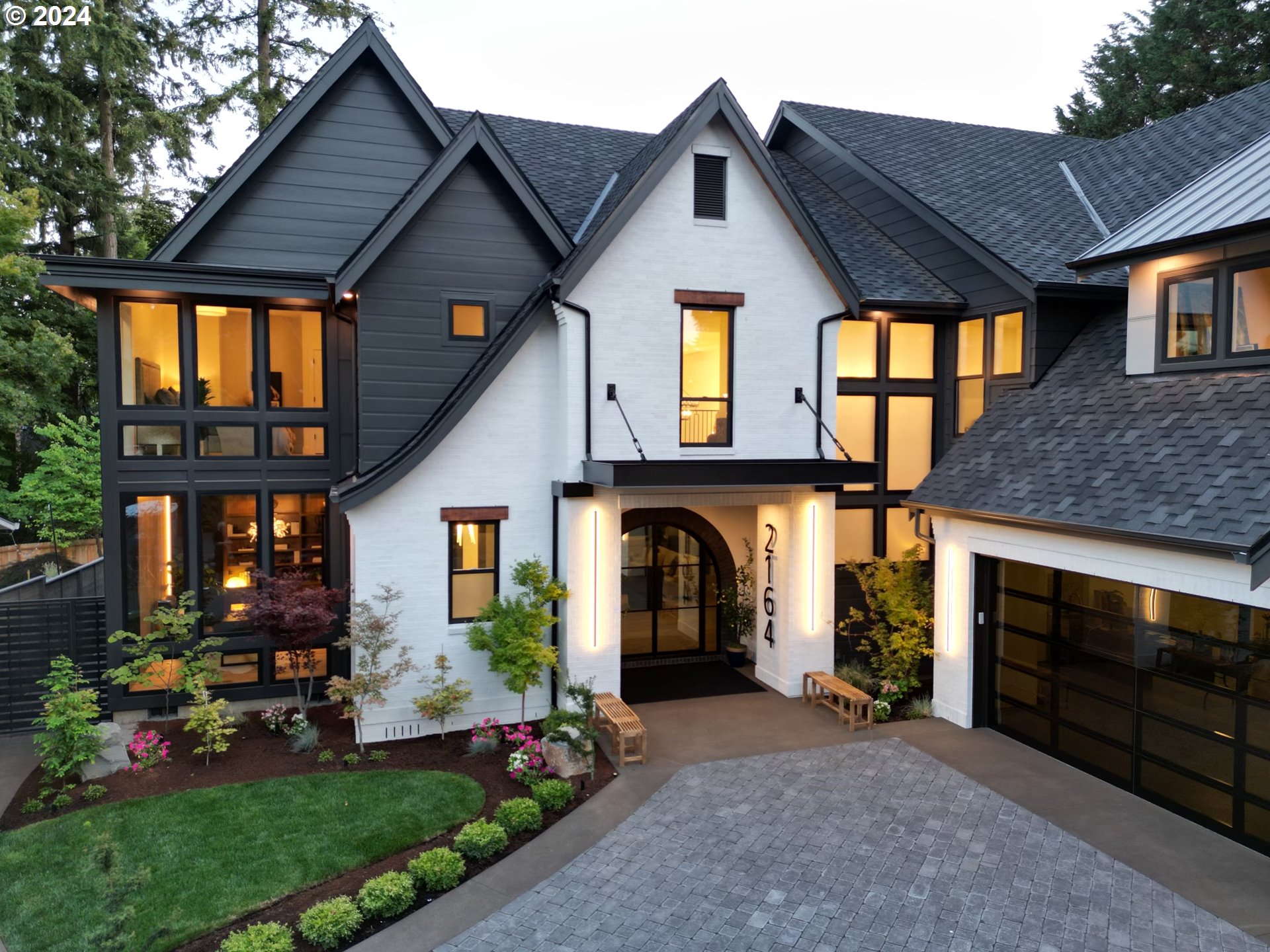 a front view of a house with a garden and plants