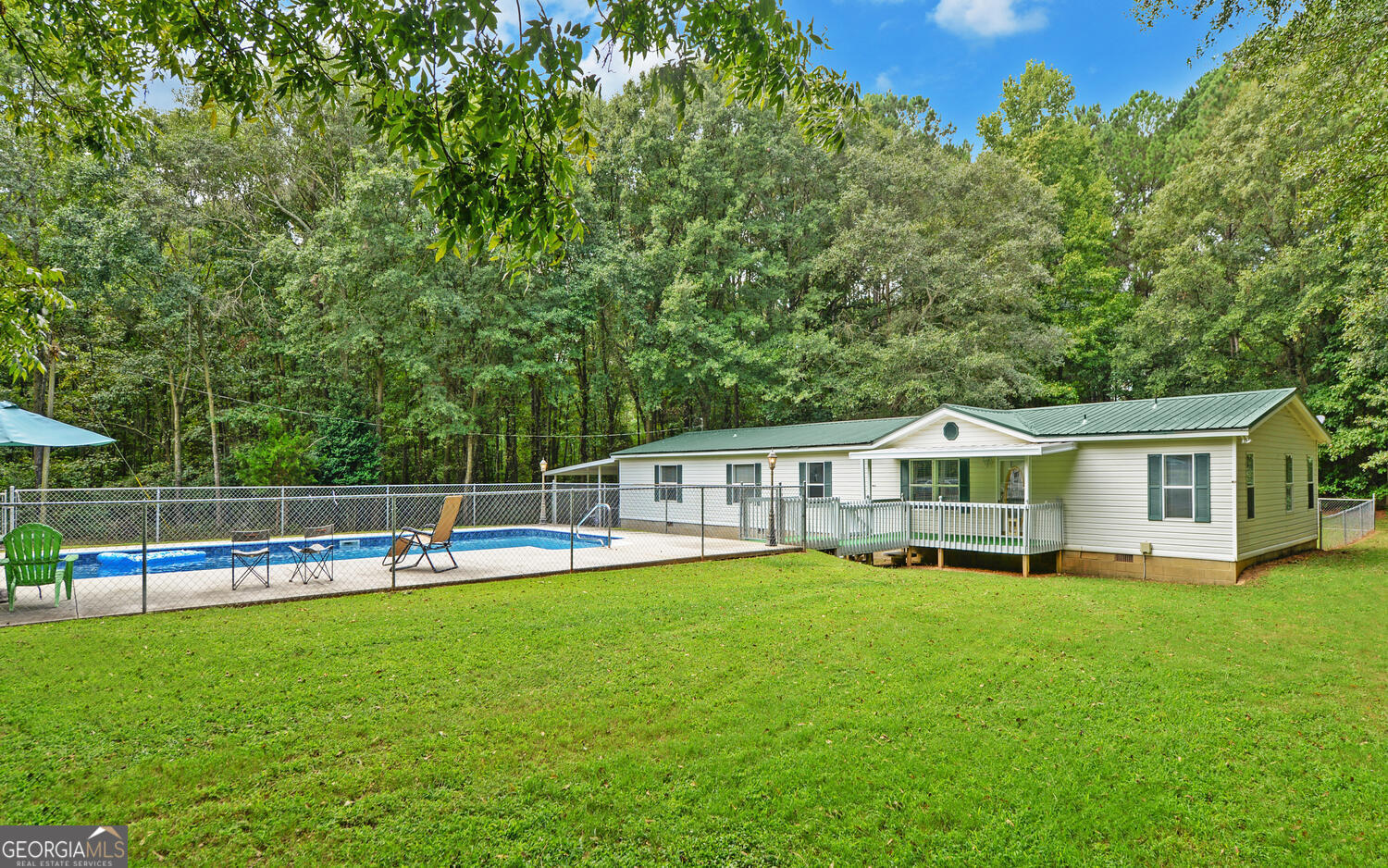 a view of a house with a backyard and a patio