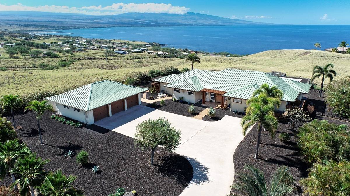 aerial view of a house with a yard