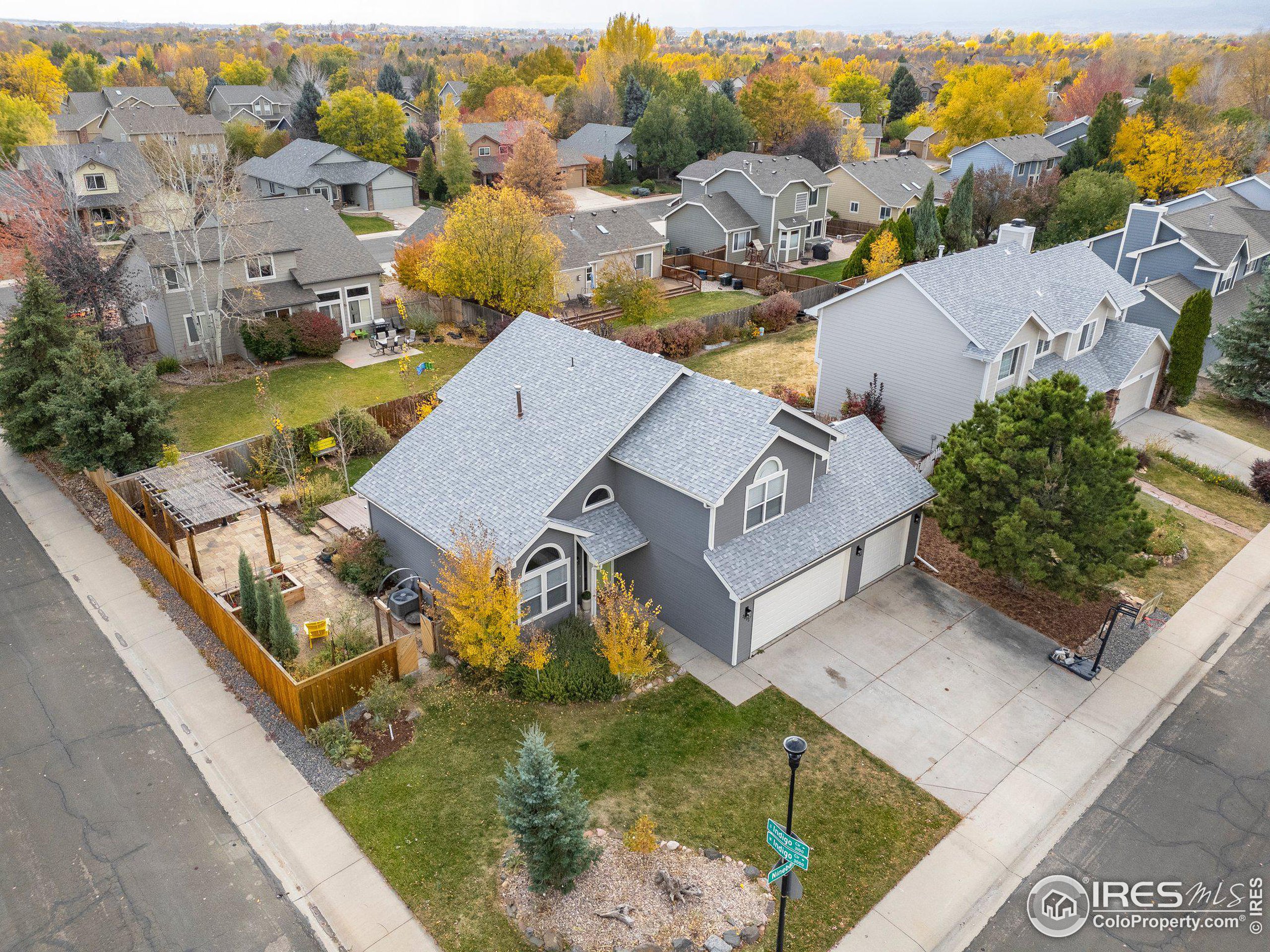 an aerial view of a house with a garden and lake view