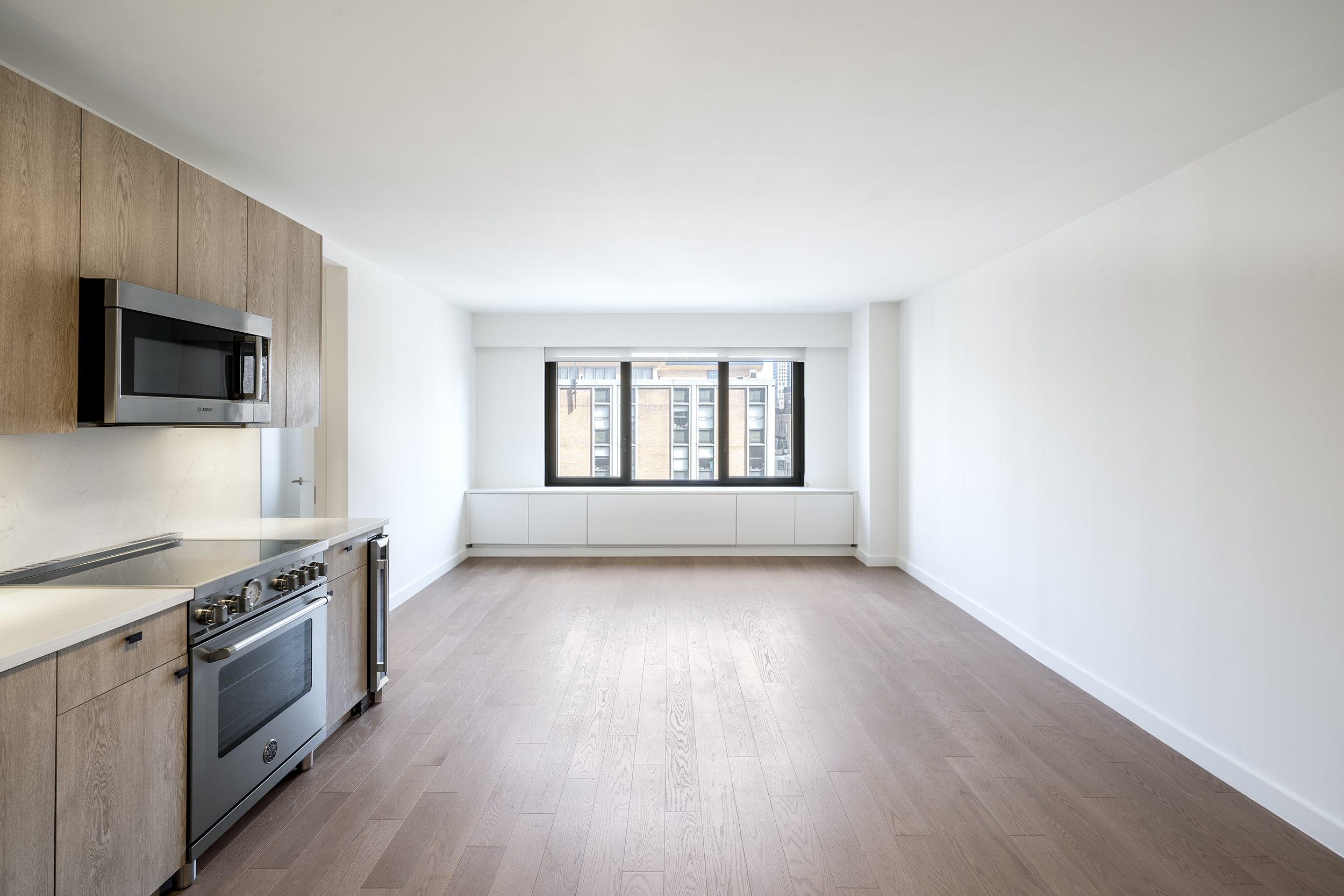 a view of a kitchen with a sink wooden floor and a window