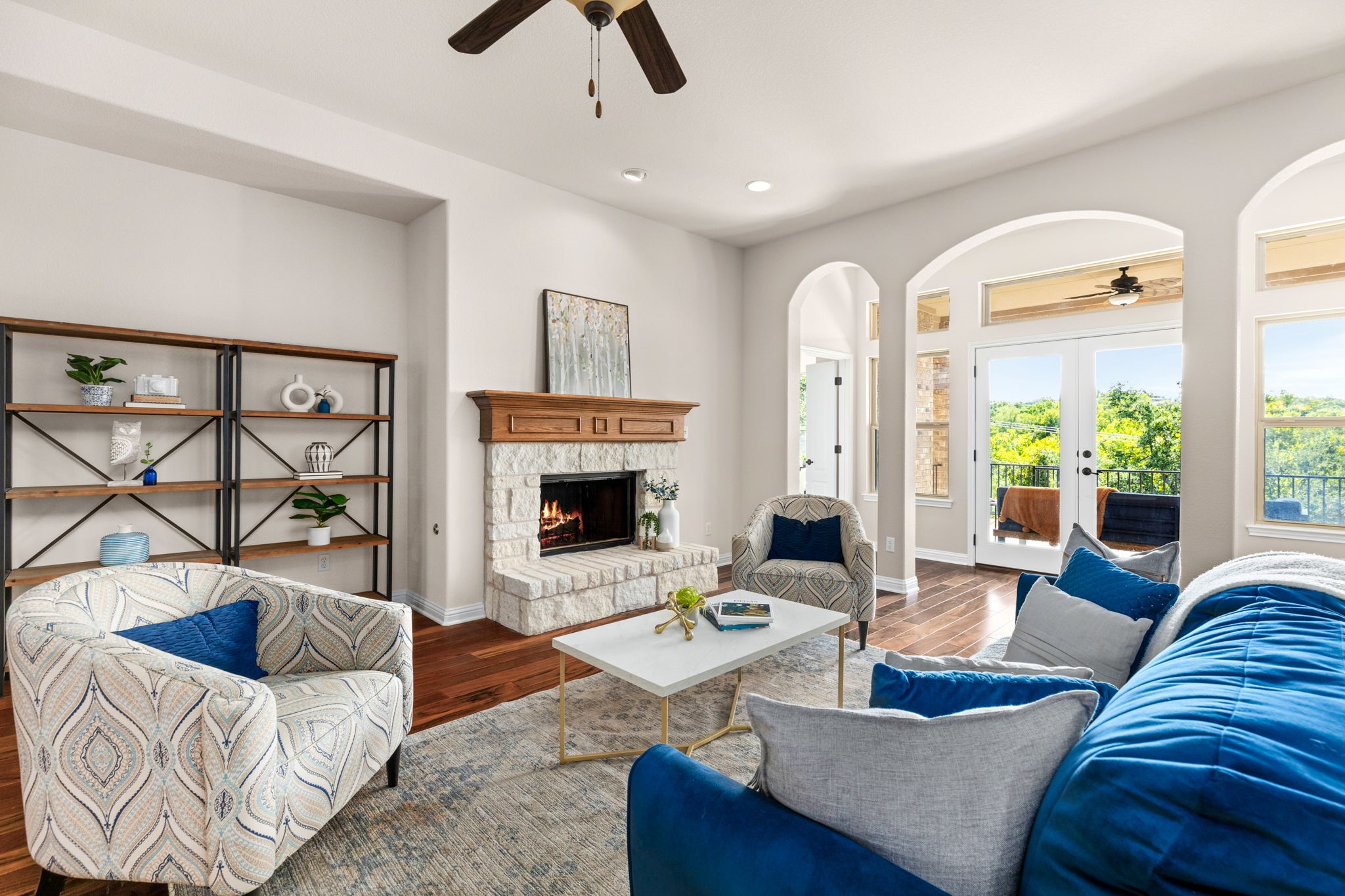 a living room with furniture a fireplace and a large window