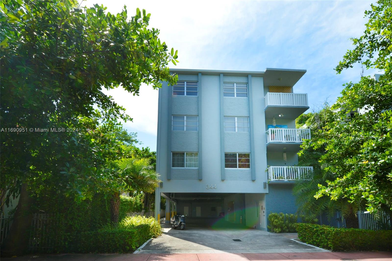 a front view of a house with plants