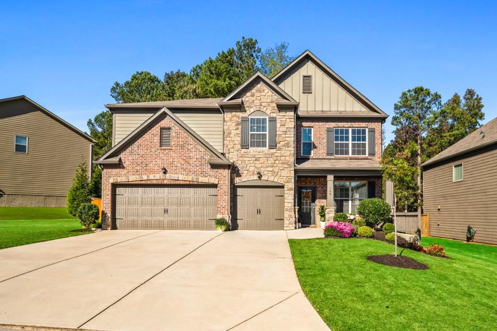 a front view of a house with a yard and garage