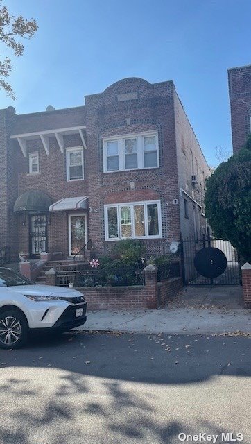 a car parked in front of a brick house