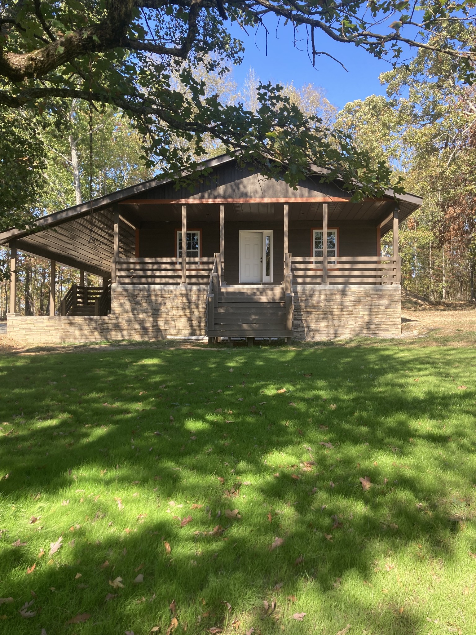 a front view of house with yard and green space