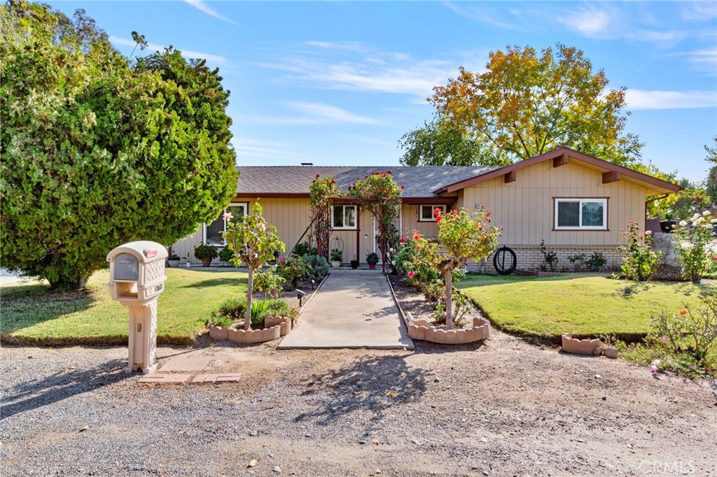 a view of a house with a yard and a garden