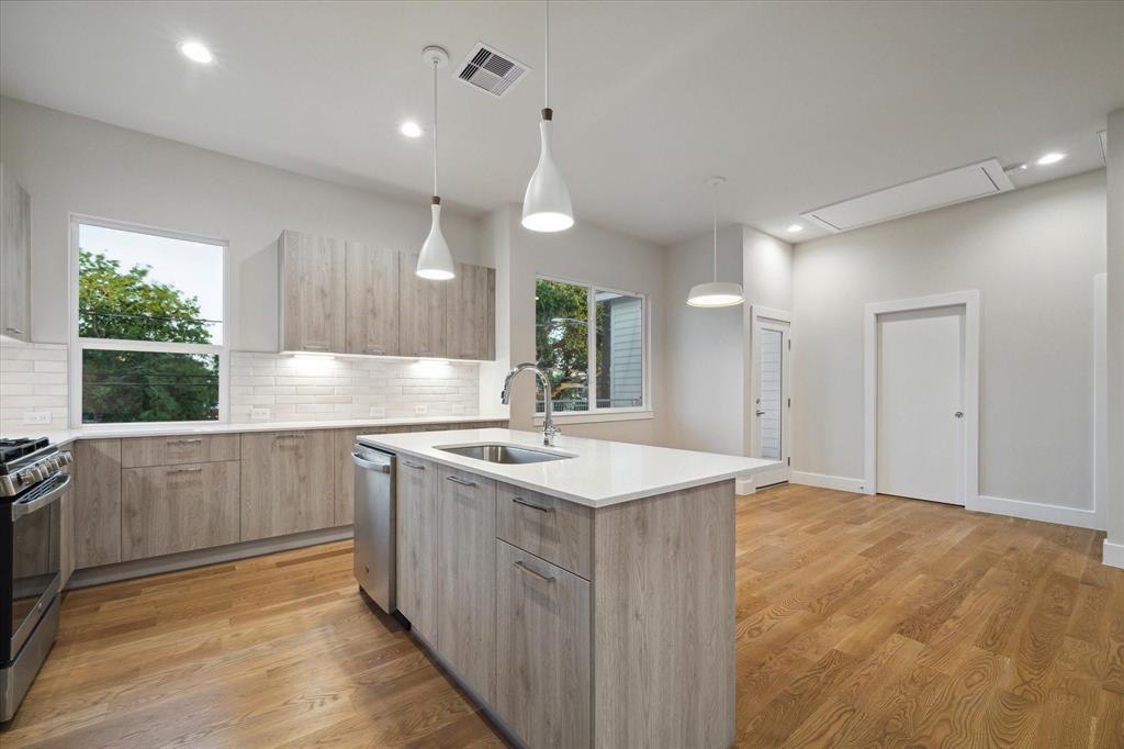 a kitchen with a sink stove and cabinets