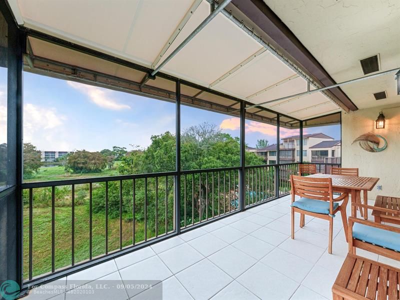 a balcony view with table and chairs