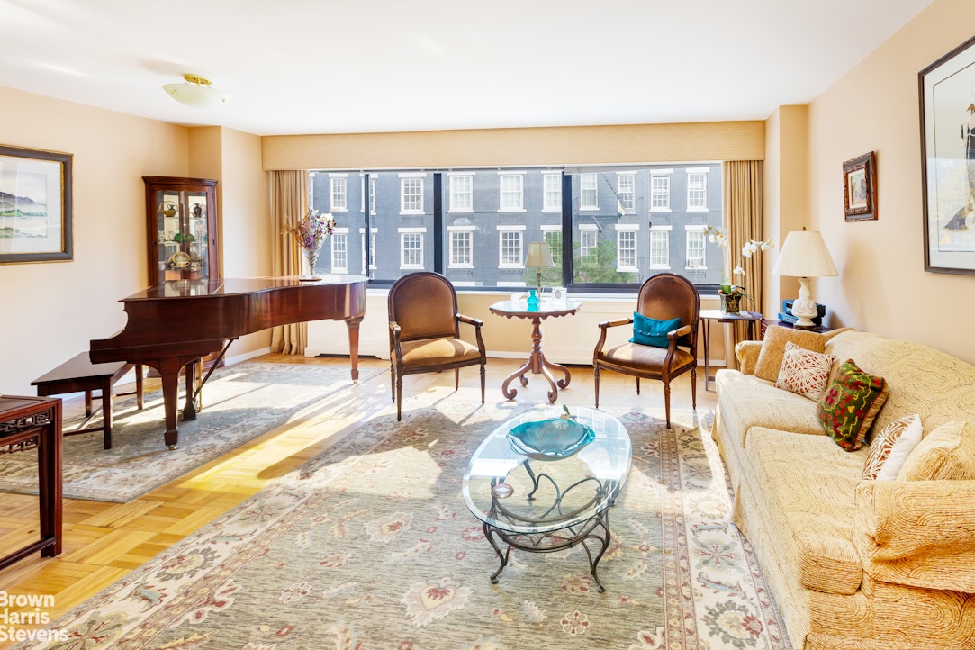 a living room with furniture and a floor to ceiling window