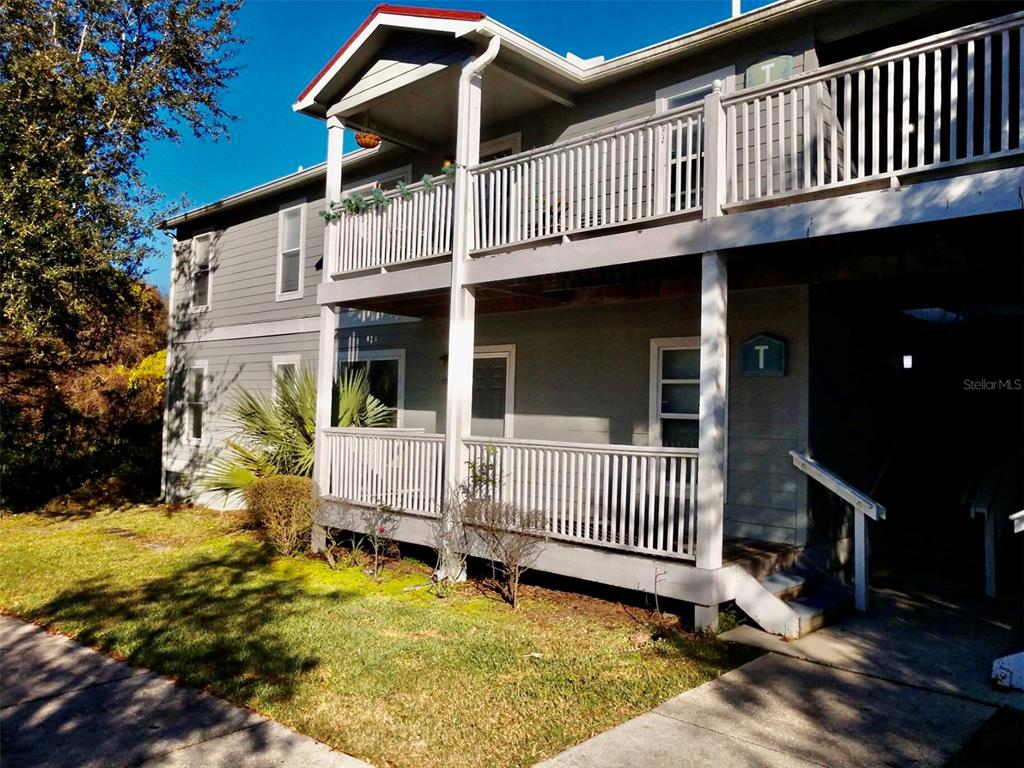 a view of a house with a wooden deck