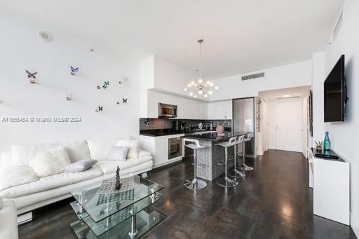 a living room with furniture a dining table and a fireplace