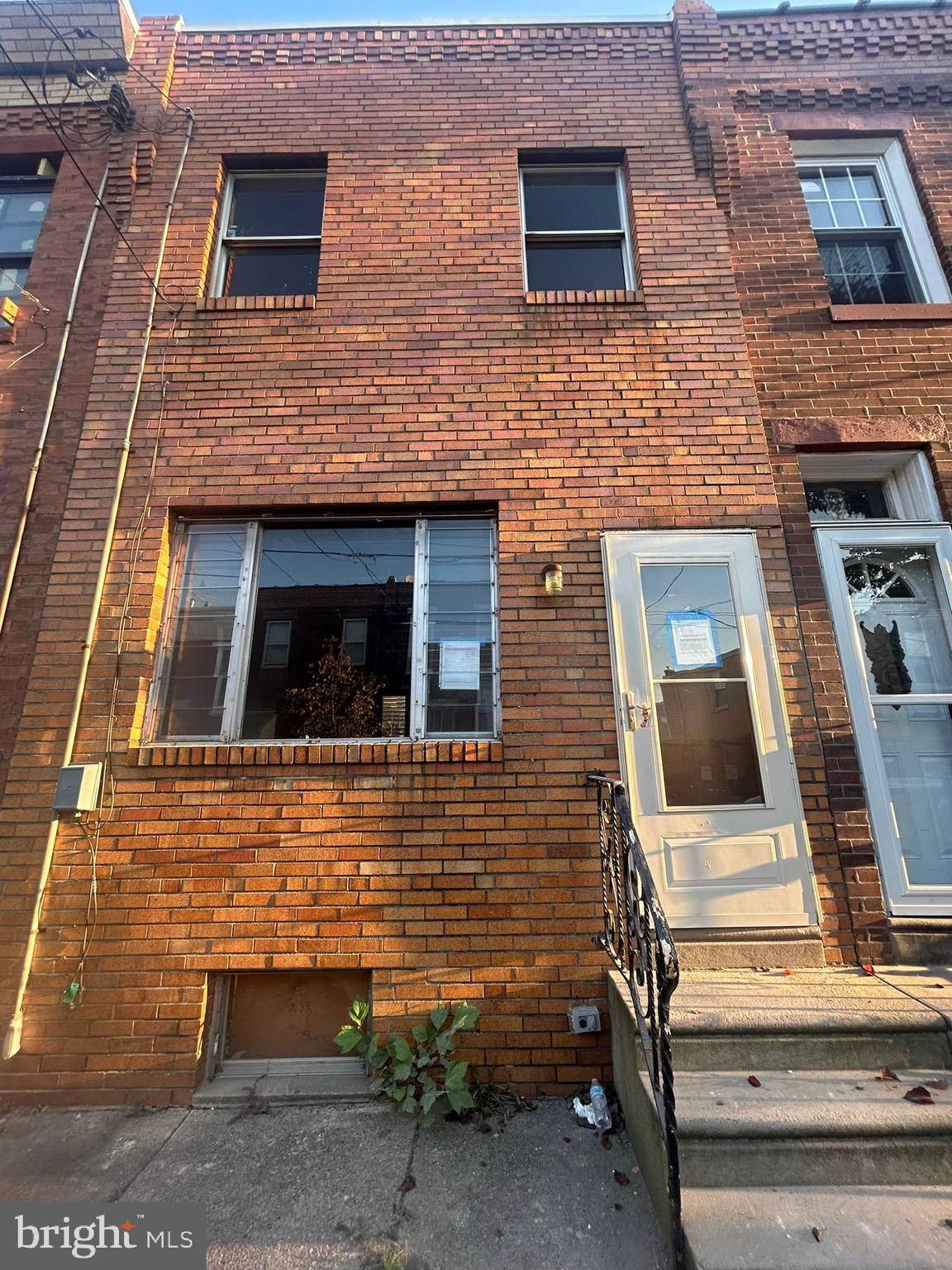 a view of a brick house with large windows