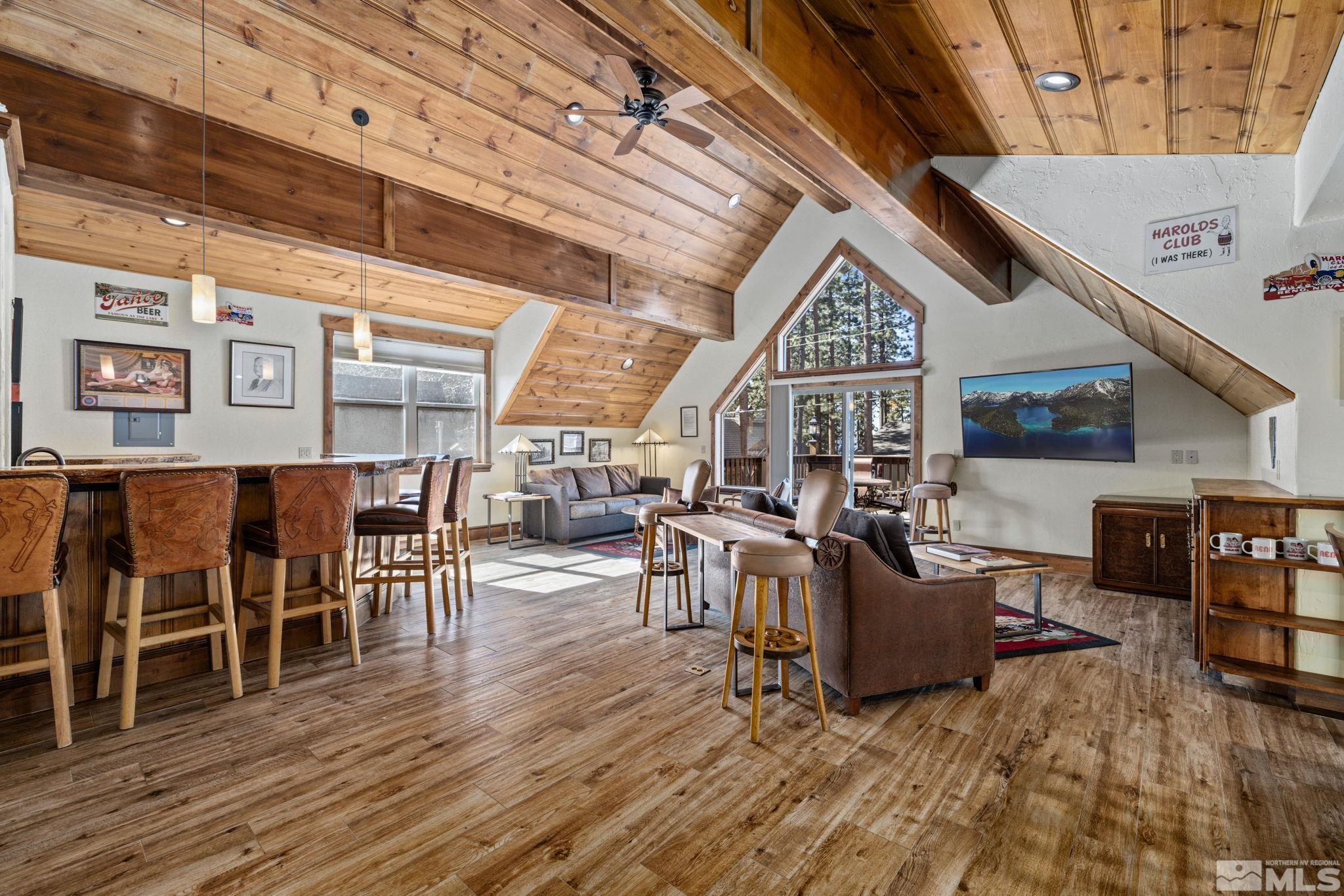 a living room with lots of furniture and a wooden floor