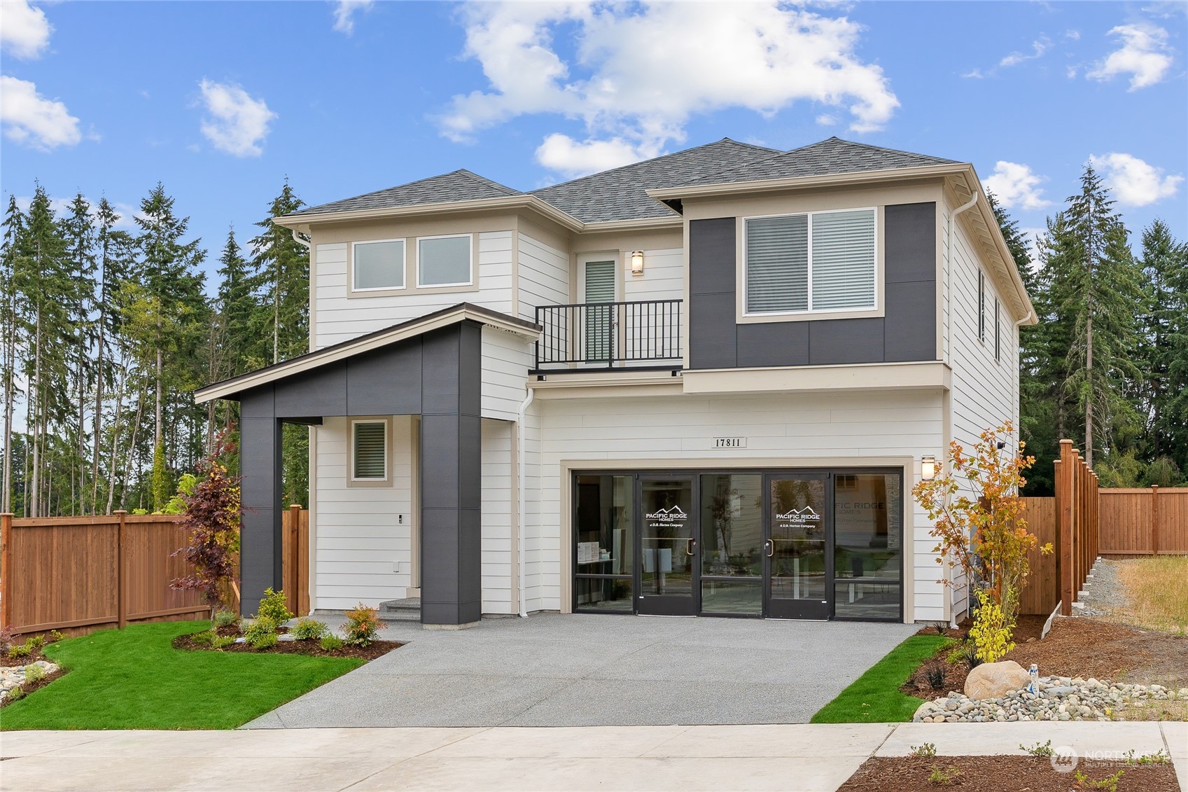 a front view of a house with a yard and garage