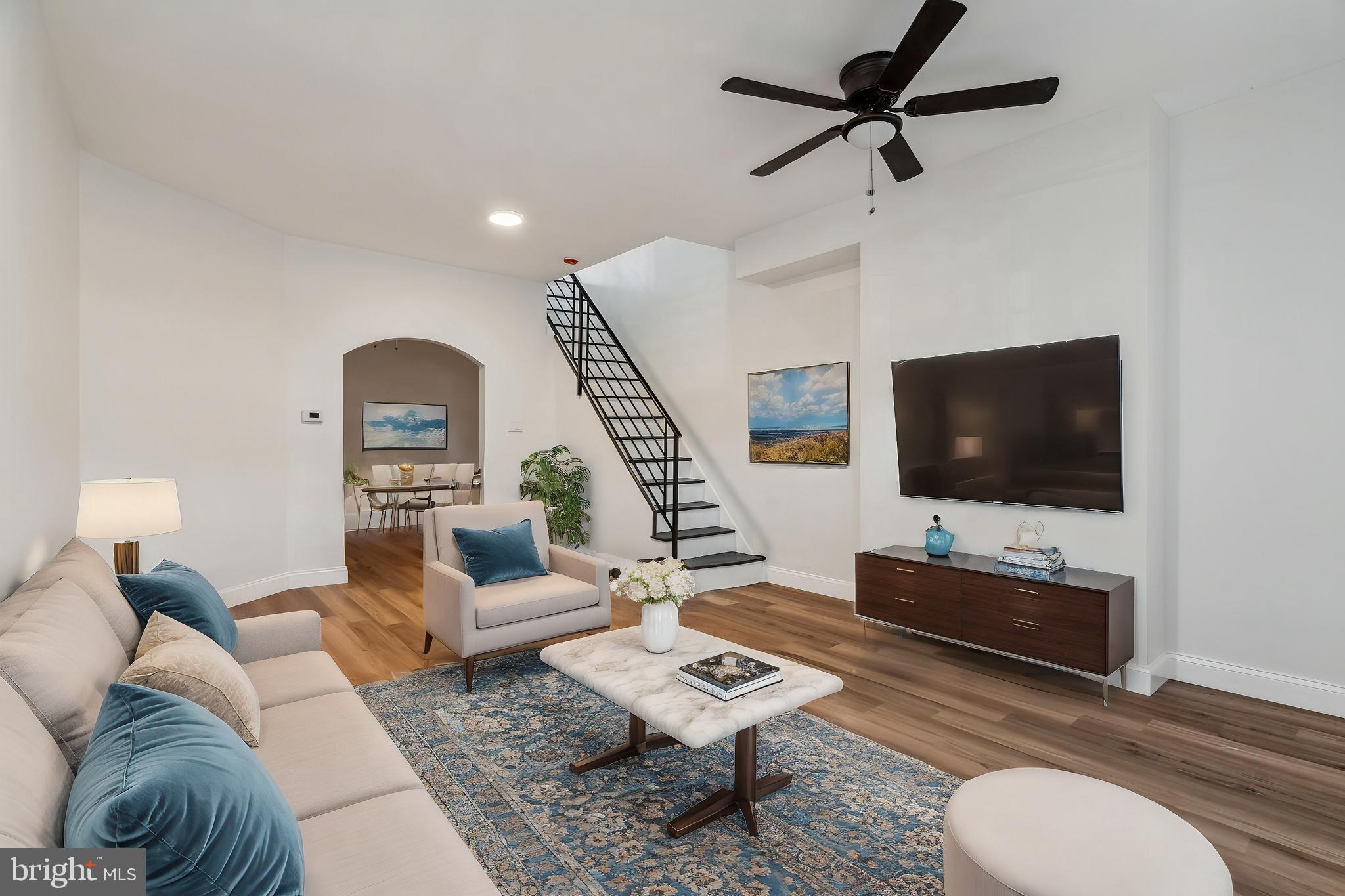 a living room with furniture a rug and a flat screen tv