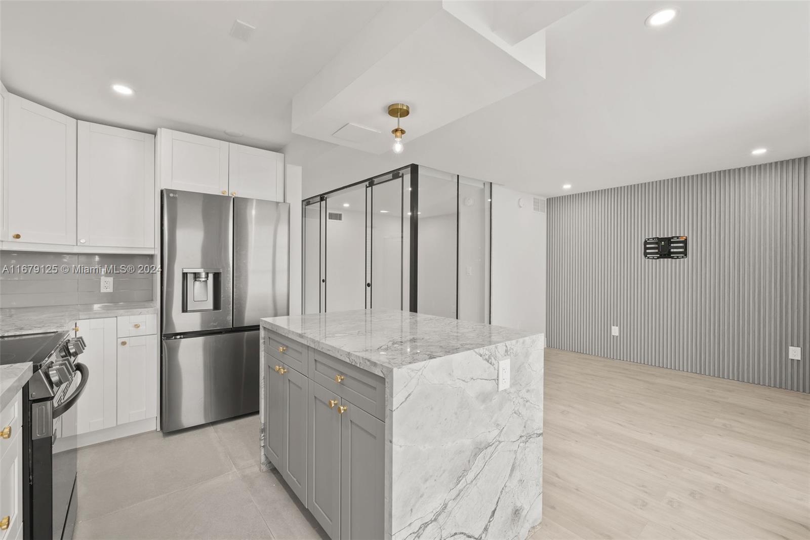 a kitchen with stainless steel appliances granite countertop a refrigerator and a sink