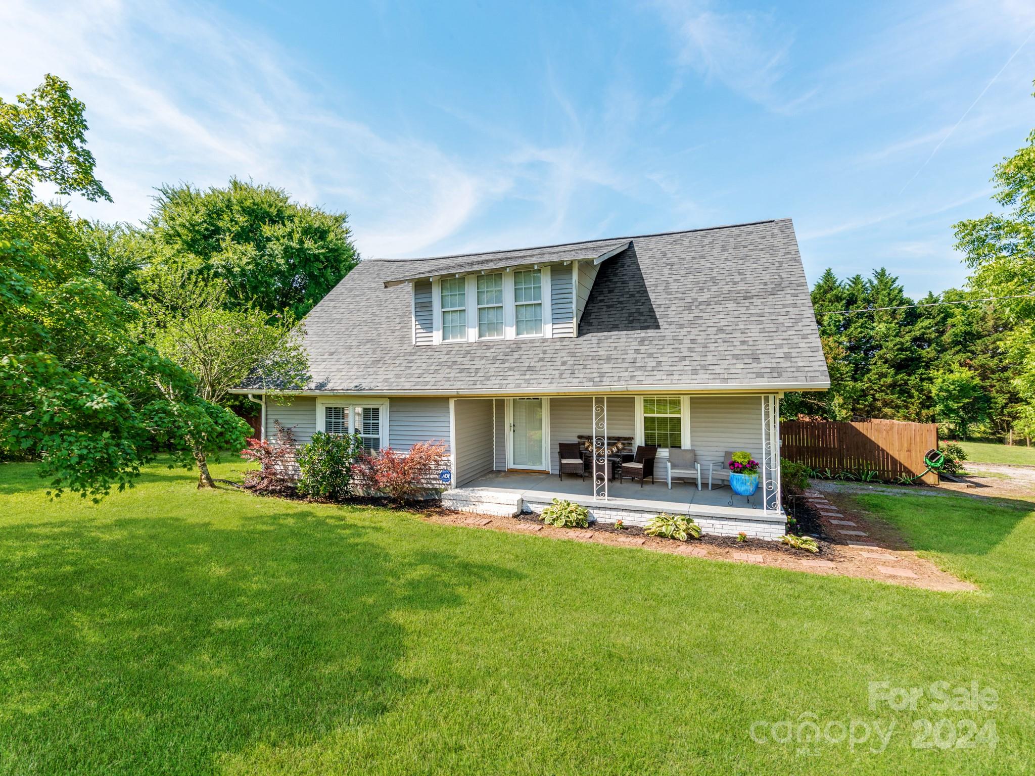 a front view of house with yard and outdoor seating