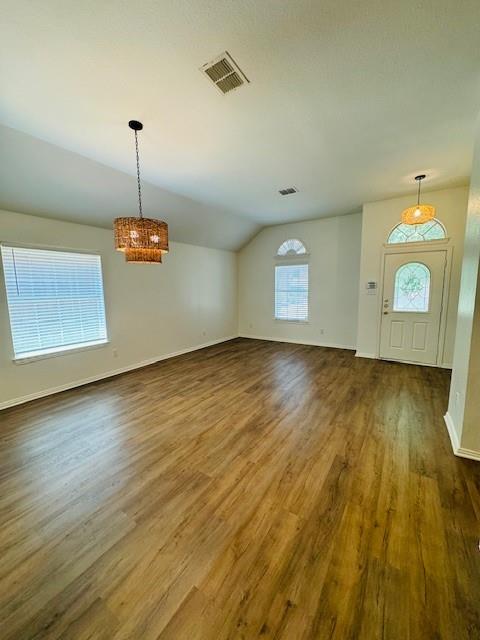 a view of a room with wooden floor and window