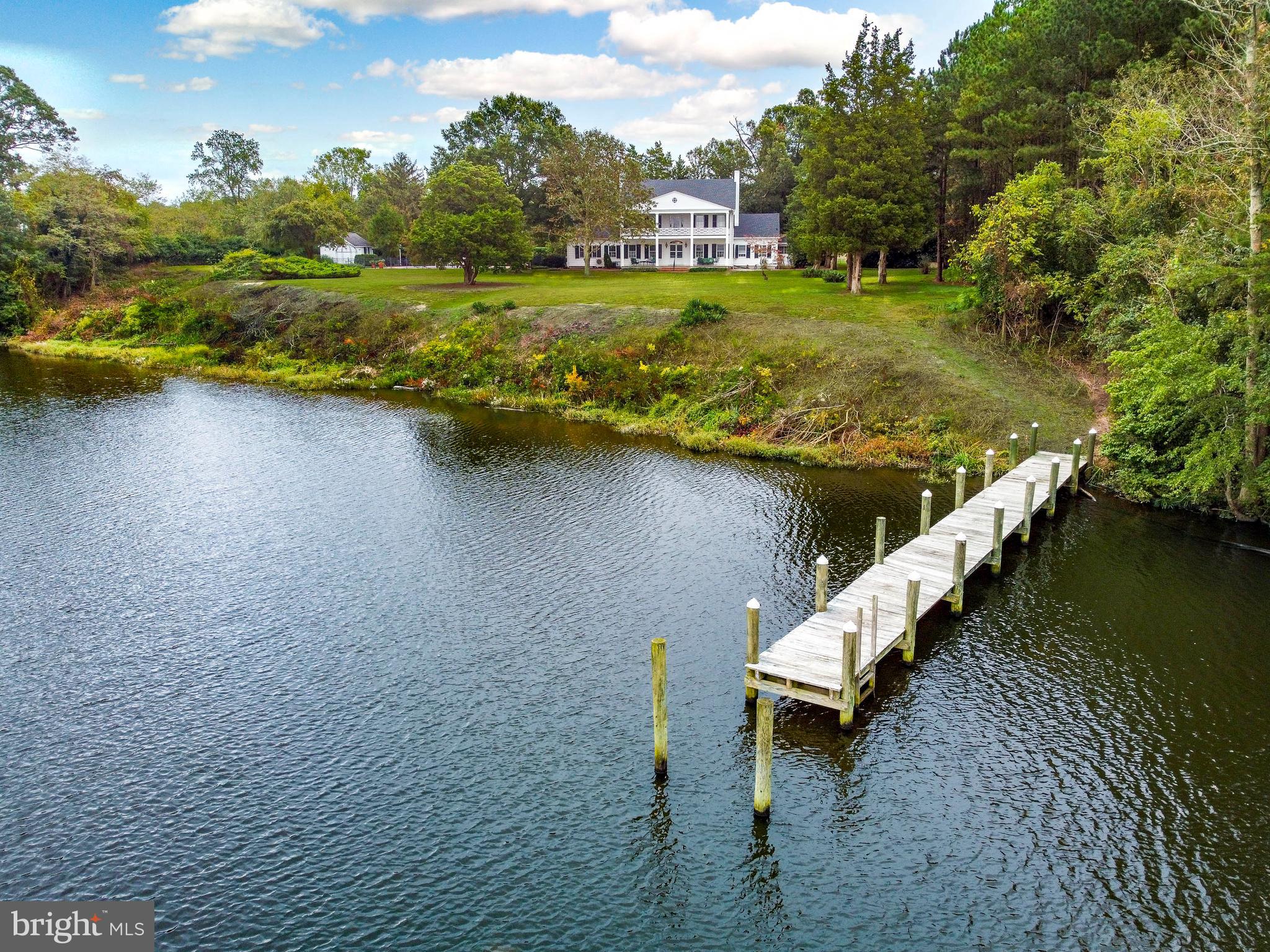 an aerial view of a house with a yard and lake view