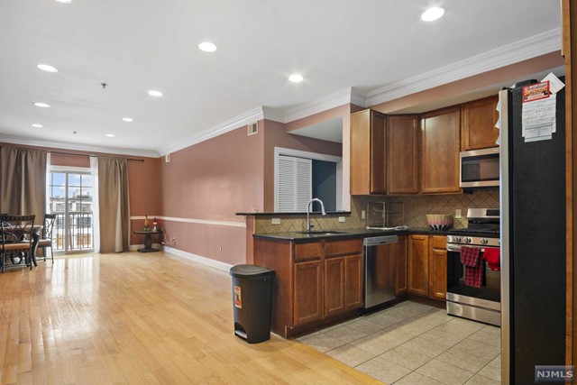 a kitchen with stainless steel appliances granite countertop a sink counter space and cabinets