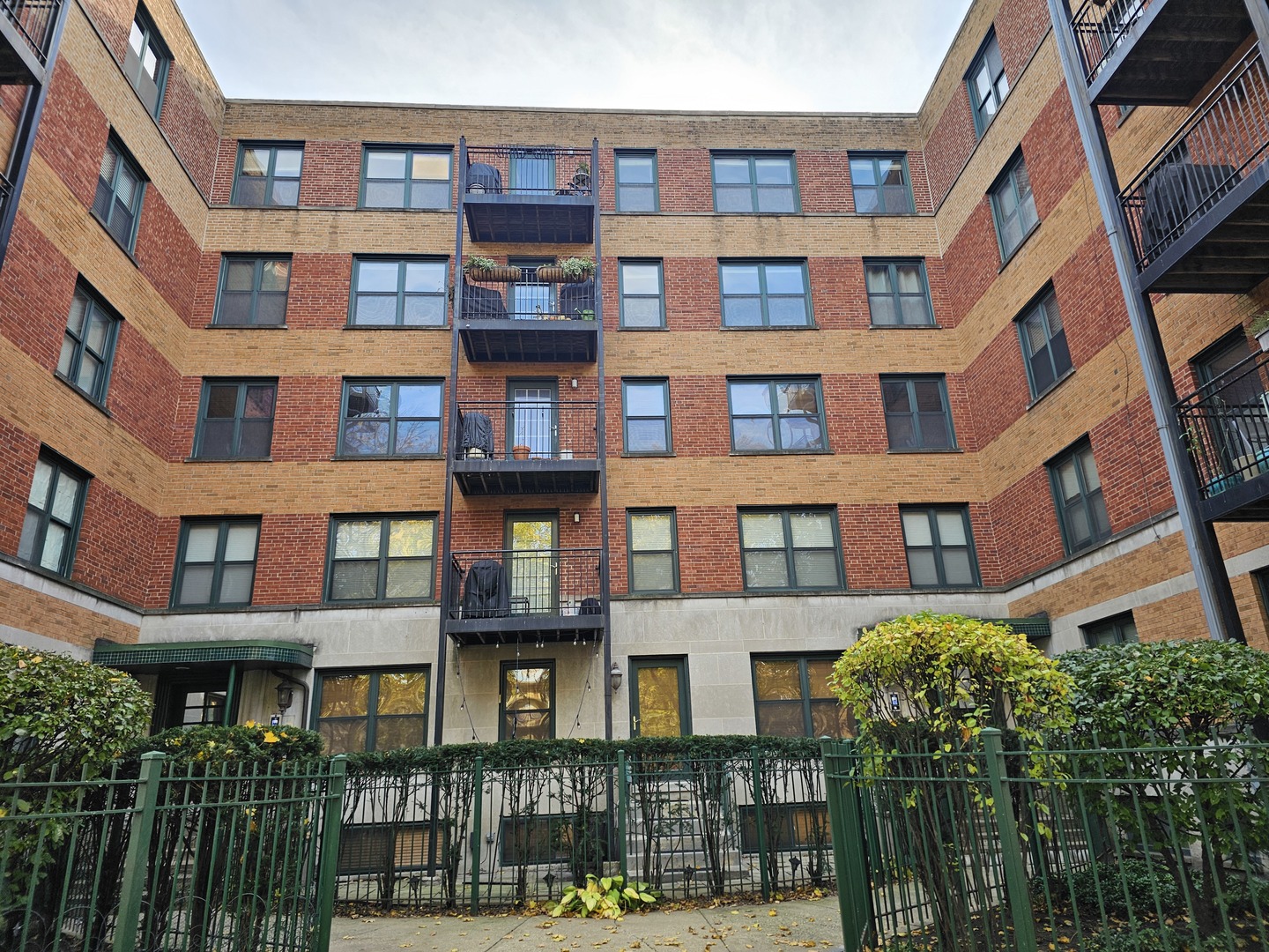 a front view of a residential apartment building with a yard