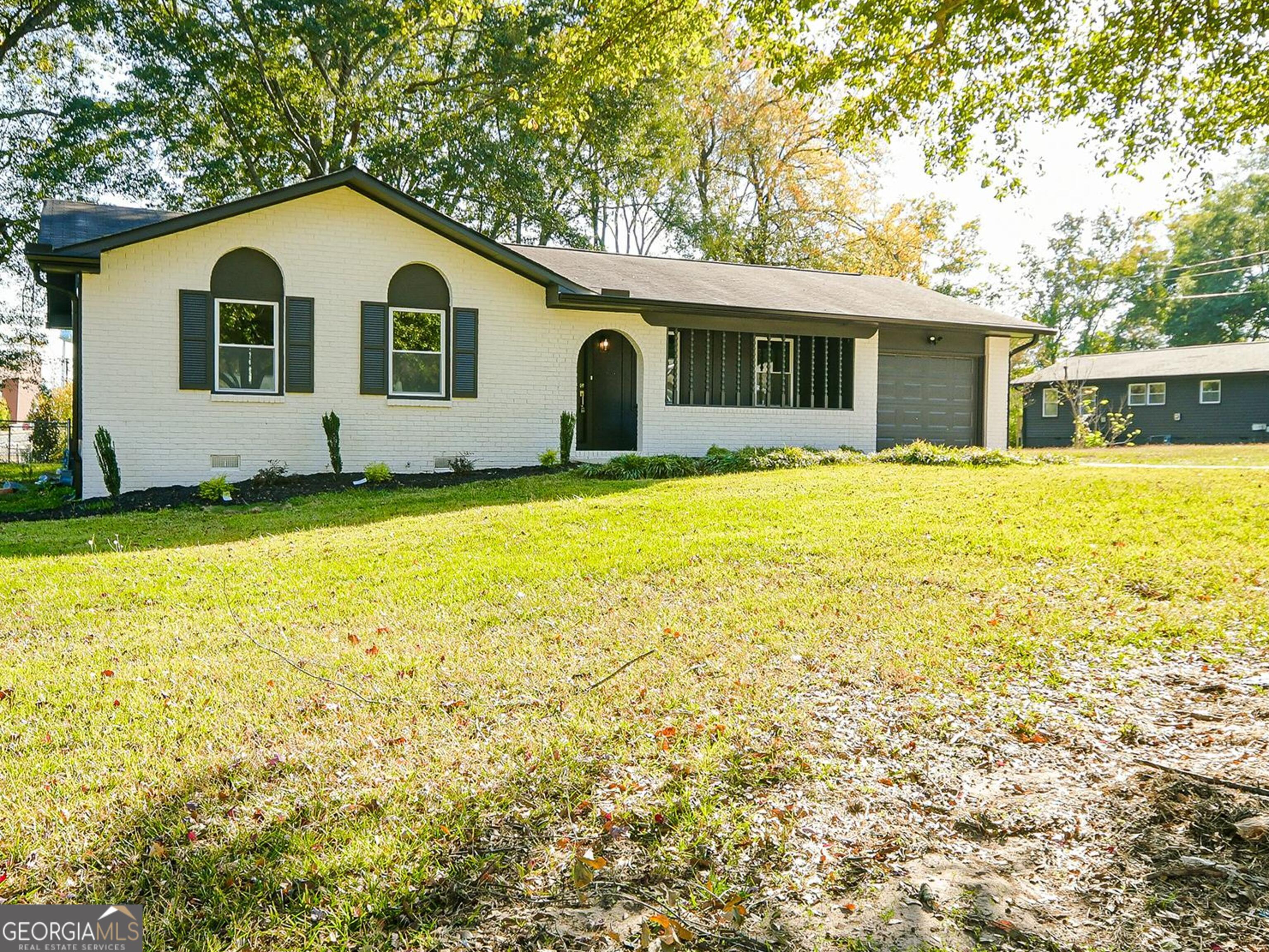 a front view of a house with a garden