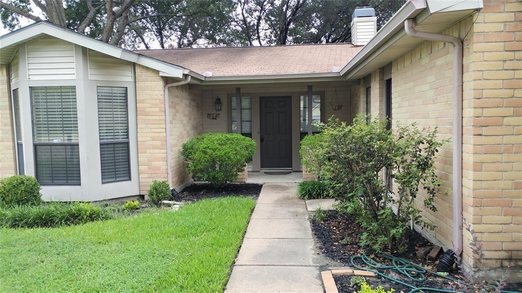 a front view of a house with a yard and plants