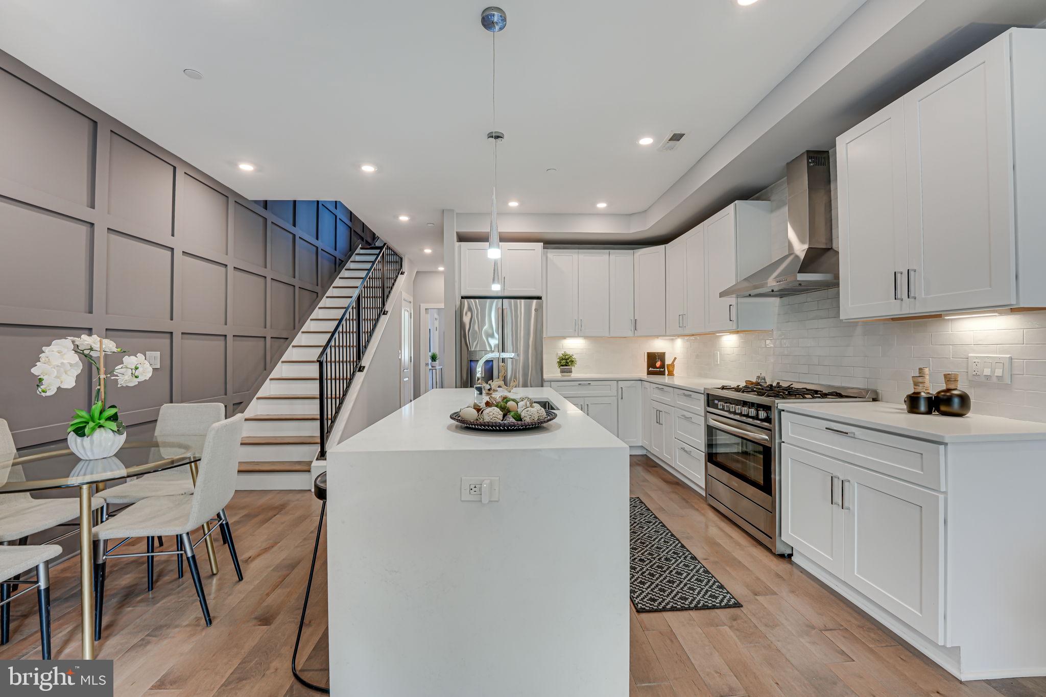 a kitchen with furniture a stove a sink and a counter top space