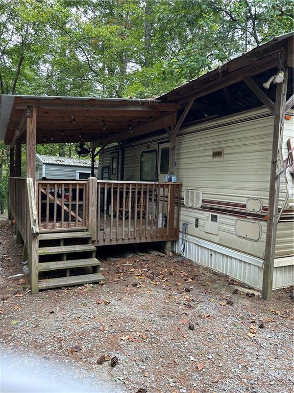 a view of backyard with small cabin and wooden fencing