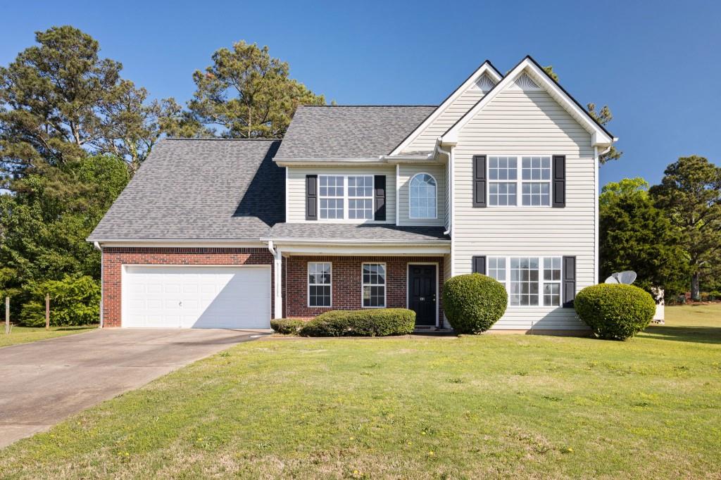 a front view of a house with a yard and garage