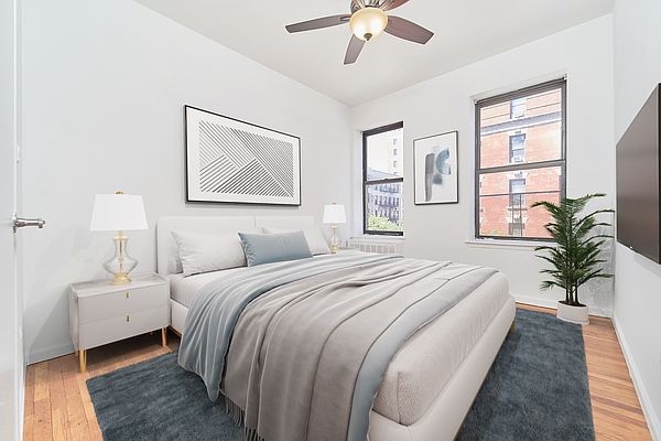 a bedroom with bed and a chandelier